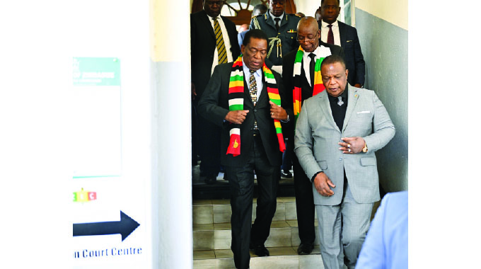 ZANU PF Presidential candidate for the 2023 harmonised elections President Mnangagwa arrives at the Nomination Court accompanied by Vice President Chiwenga and his chief elections agent who is also Minister of Justice Ziyambi Ziyambi in Harare yesterday.