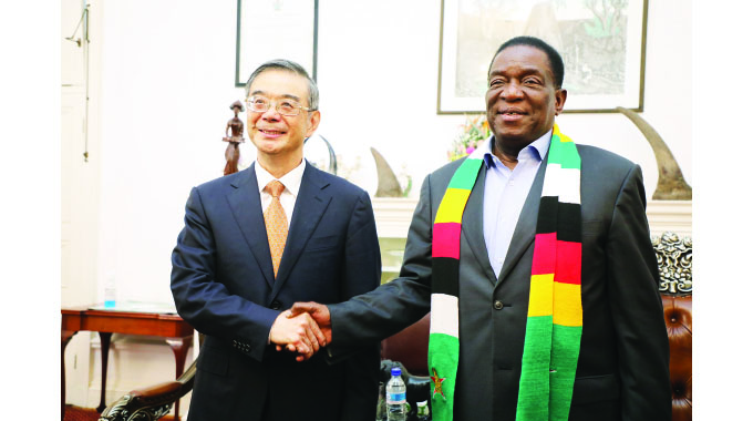 President Mnangagwa is congratulated by Chinese Special Envoy, Vice Chairman of the 14th National Committee of the Chinese People’s Political Consultative Conference, Zhou Qiang, while receiving him during a courtesy call at State House in Harare yesterday.