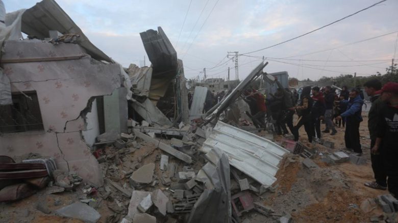 People gather around a destroyed house after an Israeli airstrike in the southern Gaza Strip city of Rafah, on Feb. 5, 2024. The death toll of Palestinians killed from Israeli strikes on the Gaza Strip has risen to 27,478, the Hamas-run Health Ministry said on Monday. (Photo by Khaled Omar/Xinhua)