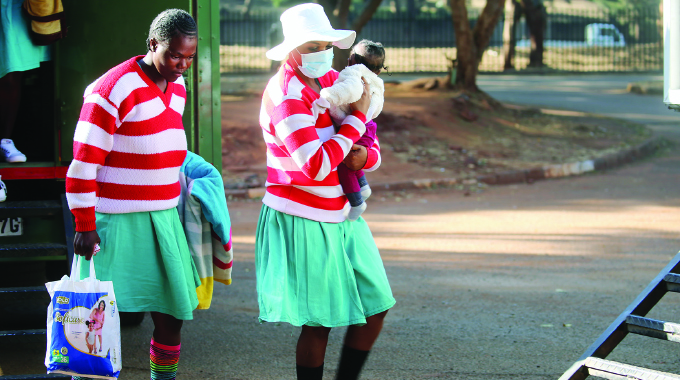 Felistus Murata, known as Mai TT, arrives at the Harare Magistrate Court while holding a baby for her sentencing yesterday.