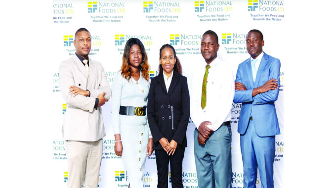 National Foods group human resources executive Alice Pawarikanda (centre) flanked by the beneficiaries of the Workers Trust Scholarship Scheme (from left) Anglebert Mungaraza, Moreblessings Mwechaka, Kelvin Mapurisa and Rickson Maingire