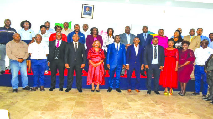 Tete Province State Secretary, Elisa Zacaias (Middle in red dress) and Tete Provincial Governor Domingos Viola (left flank) pose with the Zimbabwean business delegation currently on an outward seller mission in Mozambique, led by ZimTrade operations director Similo Nkala (third left, front row)