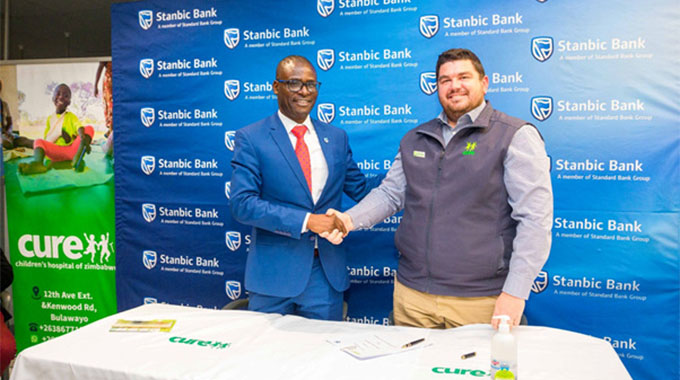 Stanbic Bank Chief Executive (CE), Solomon Nyanhongo (left) and CURE Zimbabwe Executive Director Jonathan Simpson shortly after the signing ceremony.
