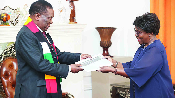 President Mnangagwa receives the Land Information Management System (LIMS) Audited Farms Database Presentation from Zimbabwe Land Commission Chairperson Tendayi Ruth Bare at State House in Harare yesterday.