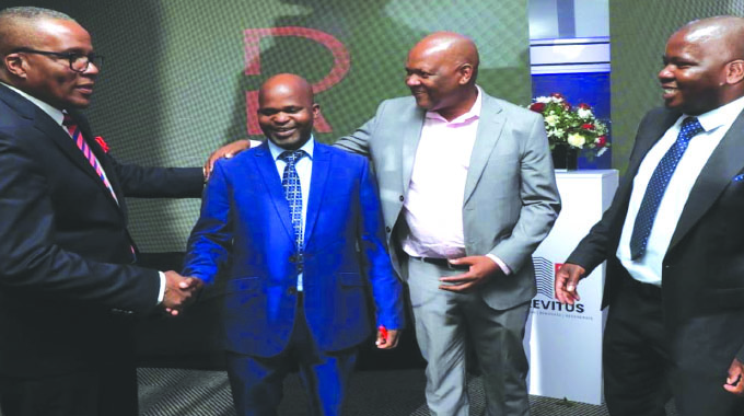 NRZ chief marketing and business development manager Mr Takunda Madanha (Second Left) is congratulated by DATVEST board chairman Mr Never Mhlanga (Left), Zimbabwe Stock Exchange CEO Mr Justin Bgoni (Third Left) and Insurance and Pensions Commission actuarial manager Mr Patrick Gombe at the launch of the NRZ CPF Revitus REIT in Bulawayo yesterday