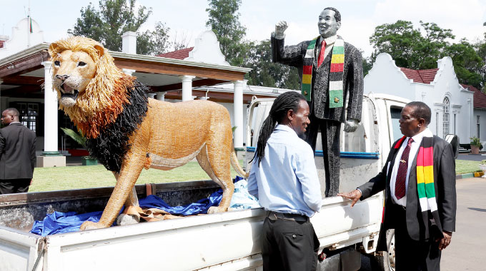 President Mnangagwa receives artwork from Cassidy Mwashusha of Chitungwiza at State House in Harare yesterday.