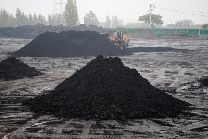 An excavator sifts through dunes of low-grade coal near a coal mine in Pingdingshan, Henan province, China [File: Aly Song/Reuters]