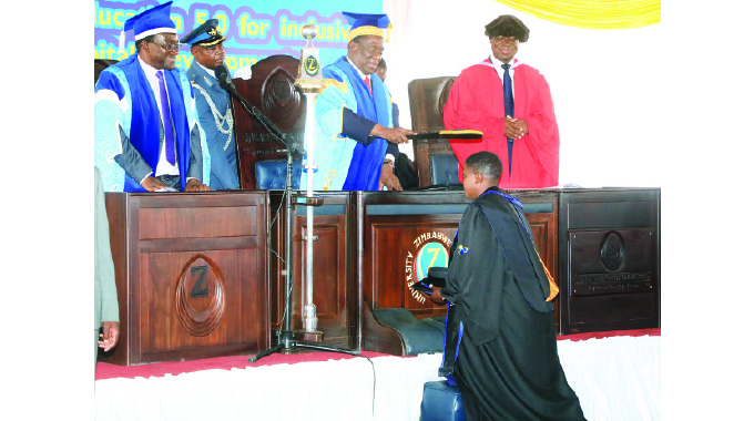 President Mnangagwa caps Faith Makufa who graduated with a first class Bachelor of Commerce Honours degree in Human Resources and Labour Relations Management at the Zimbabwe Open University’s graduation ceremony in Hatcliffe, Harare, yesterday. She also won the Best Student award with a book prize, the overall Best Student and received The Emmerson Dambudzo Mnangagwa Chancellor’s award.