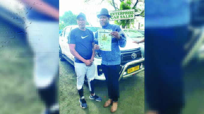 Jeys Marabini holds the papers in front of his new vehicle