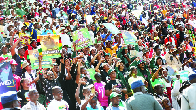 Part of the crowd wave at the President and the First Lady after burial of the three heroes yesterday
