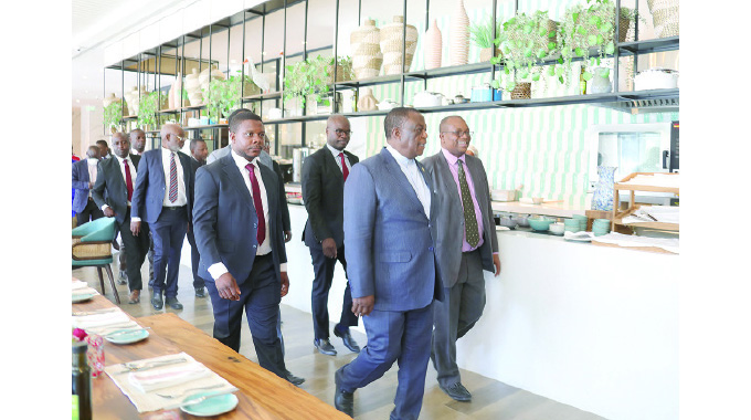 Vice President Constantino Chiwenga and Hyatt Regency Hotel (formerly Meikles Hotel) general manager Tinashe Munjoma tour the hotel which is under renovations in Harare yesterday.